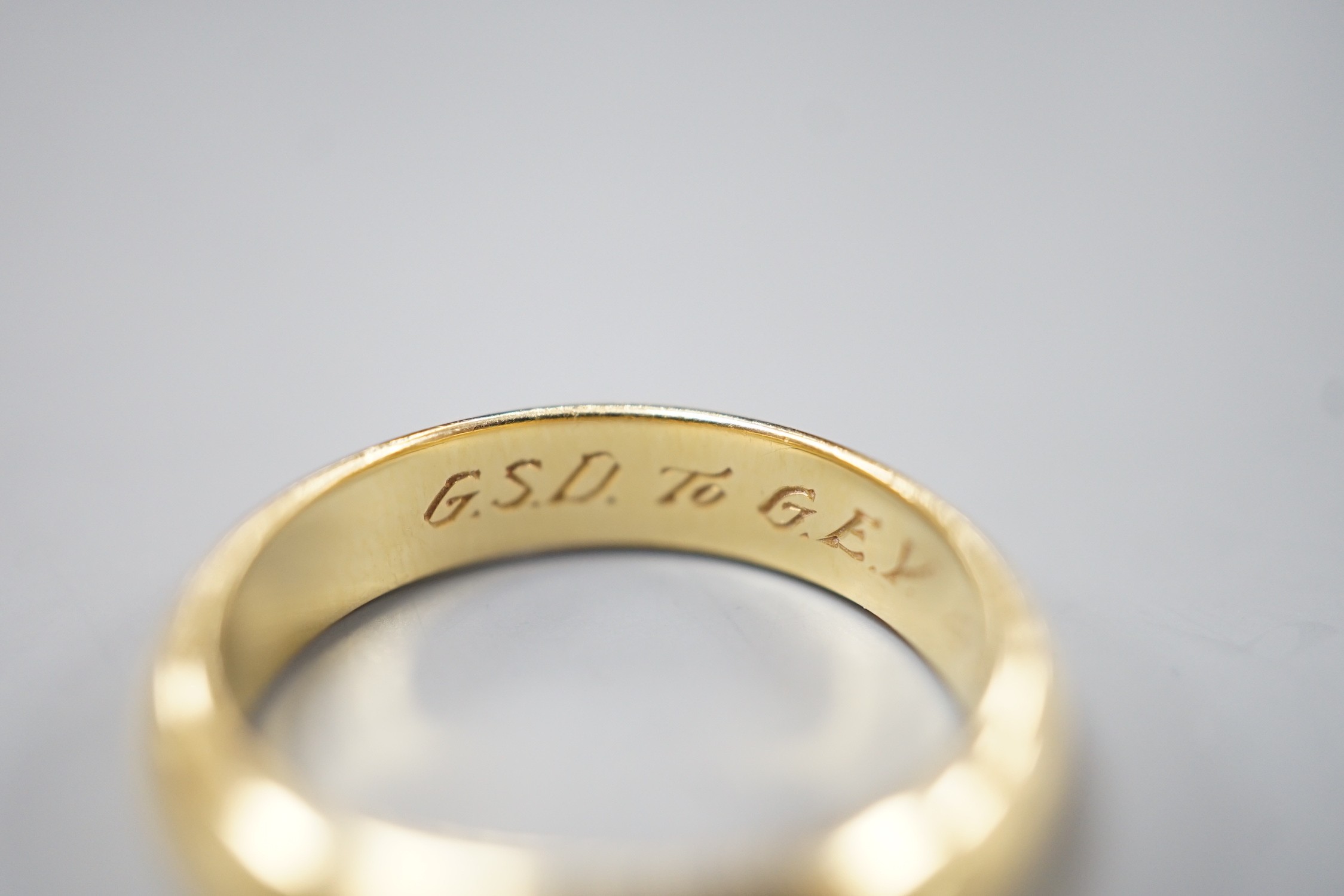 A 1970's 18ct gold wedding band, with engraved inscription, size O/P, 6.7 grams.